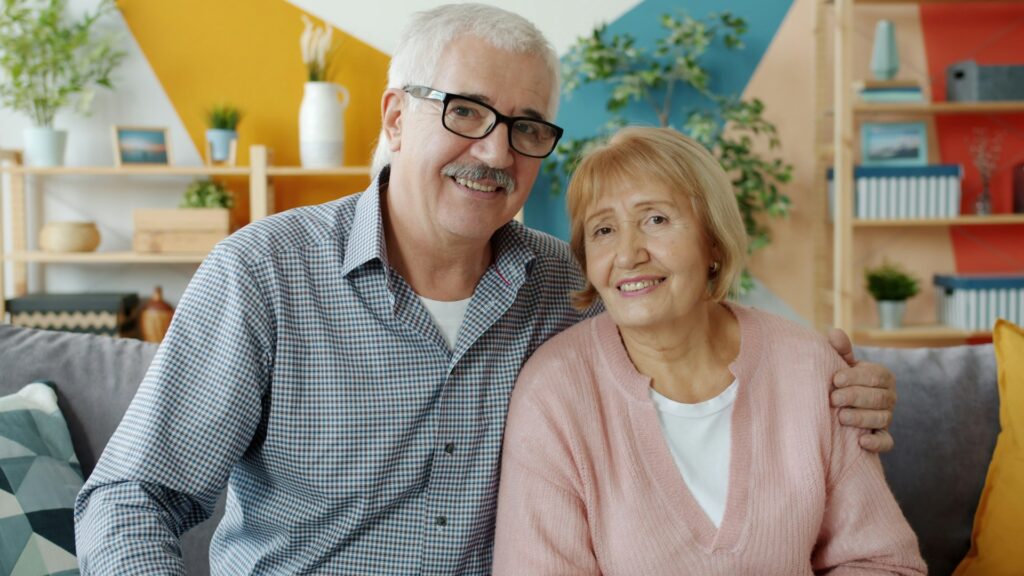 Happy senior couple relaxing in a vibrant and cheerful living space