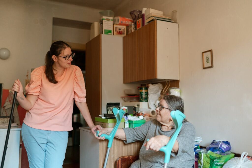 A In-home caregiver helping an elderly woman with housekeeping 