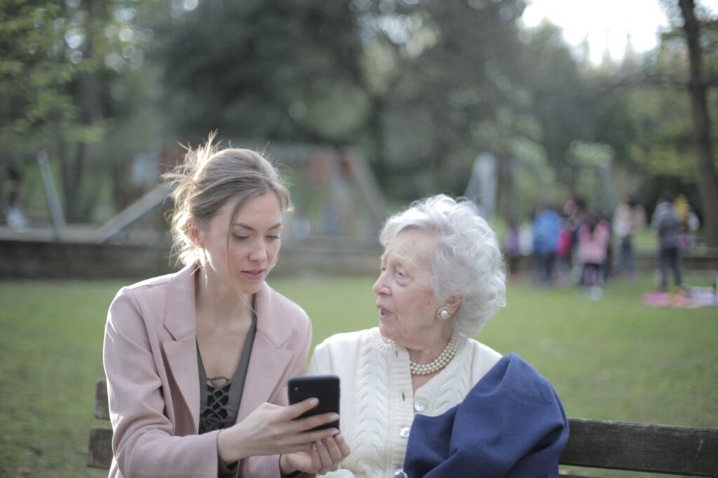 Adult daughter sitting with elderly mother discussing home care options